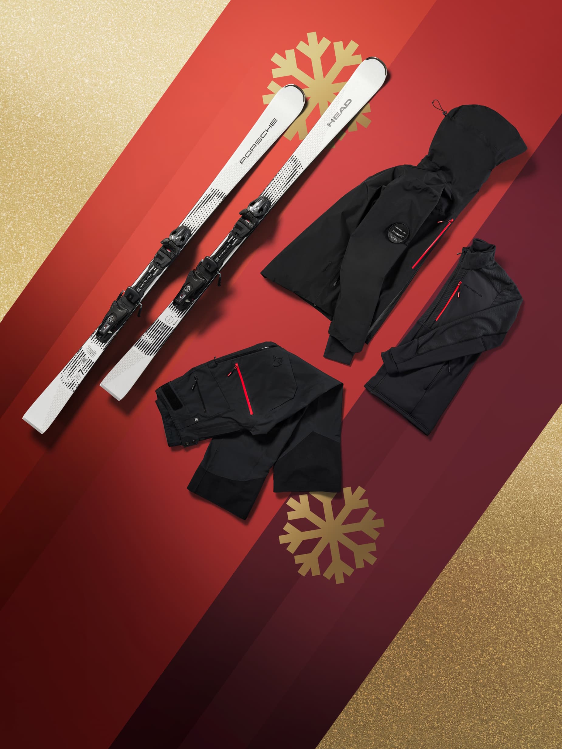 Weiße Porsche-Ski und schwarze Skiausrüstung auf rotem und goldenem Hintergrund mit Schneeflockendesign.