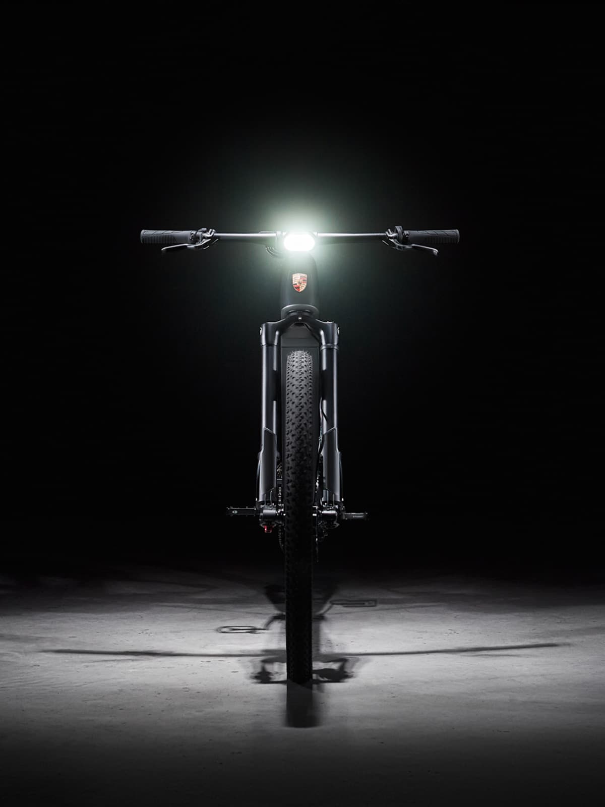 Porsche eBike from the front with lightning in a dark environment