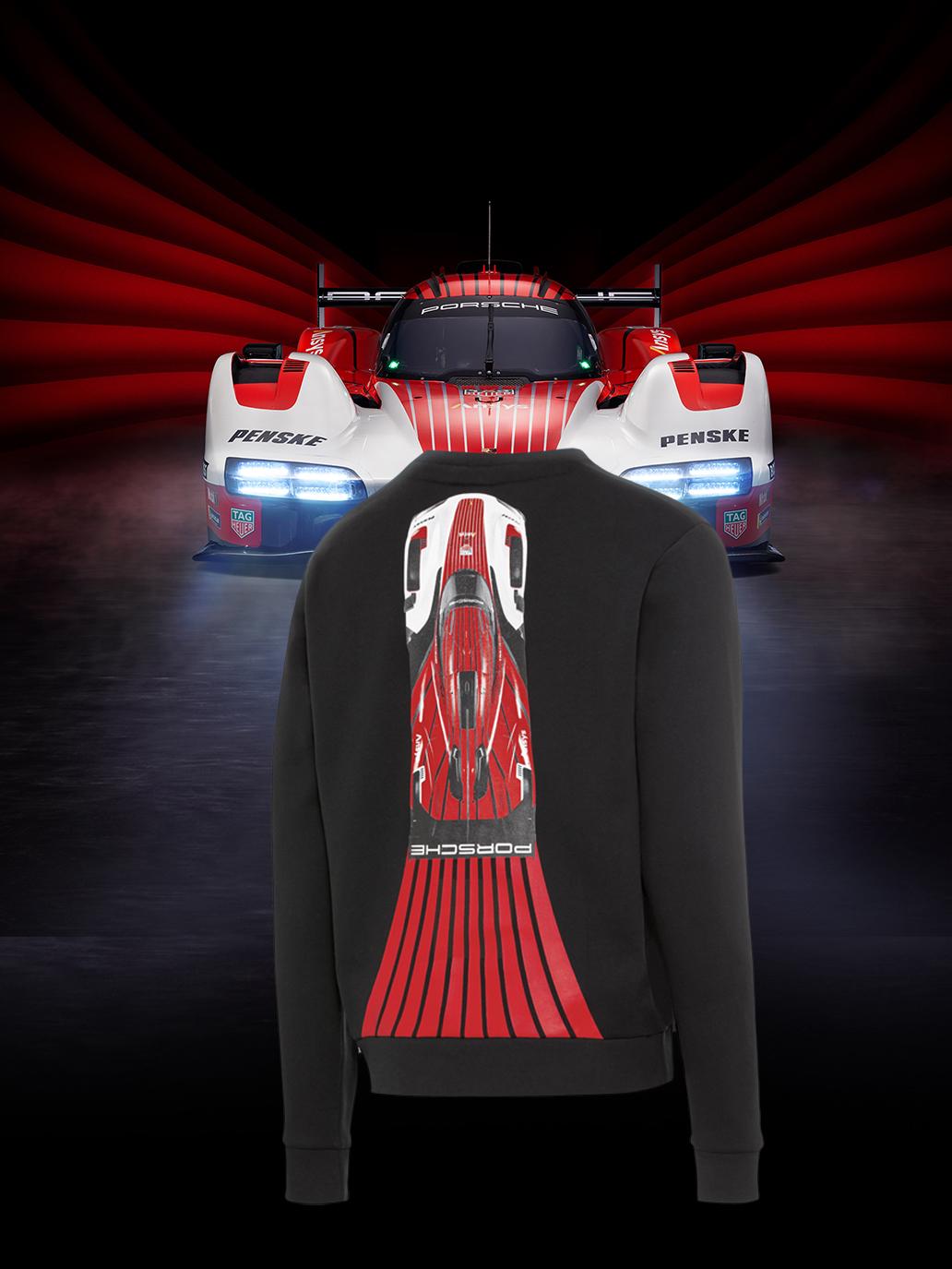 Close-up of a Porsche motorsport collection pullover with a race car in the background