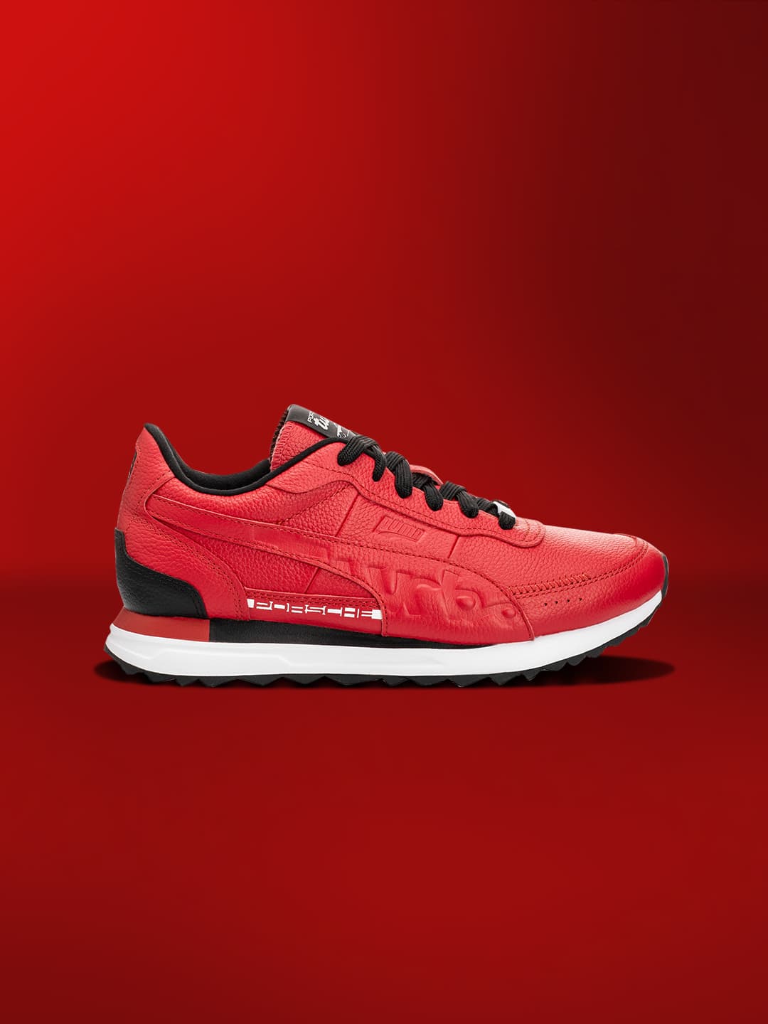 Red colored sneaker on a red background