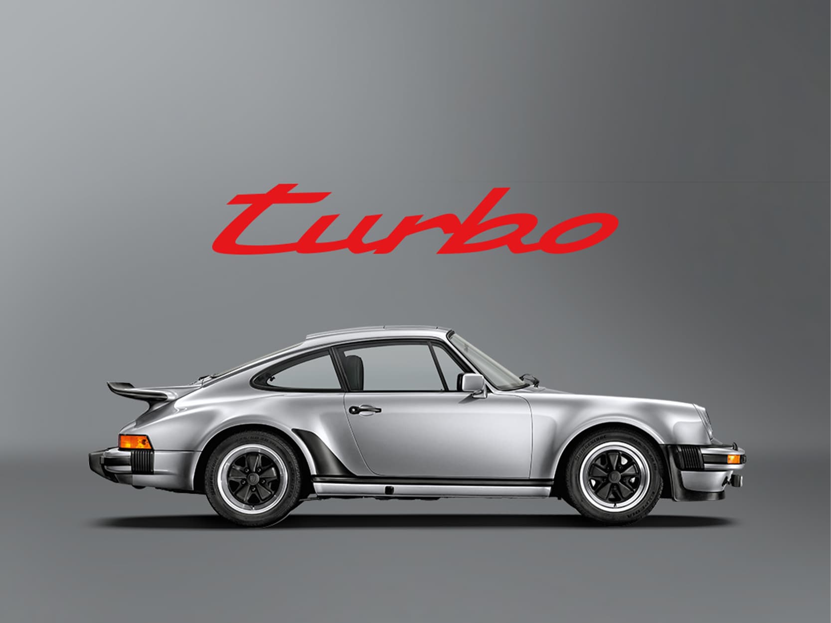 Grey historic Porsche 911 Turbo on a grey background with a red lettering -turbo-