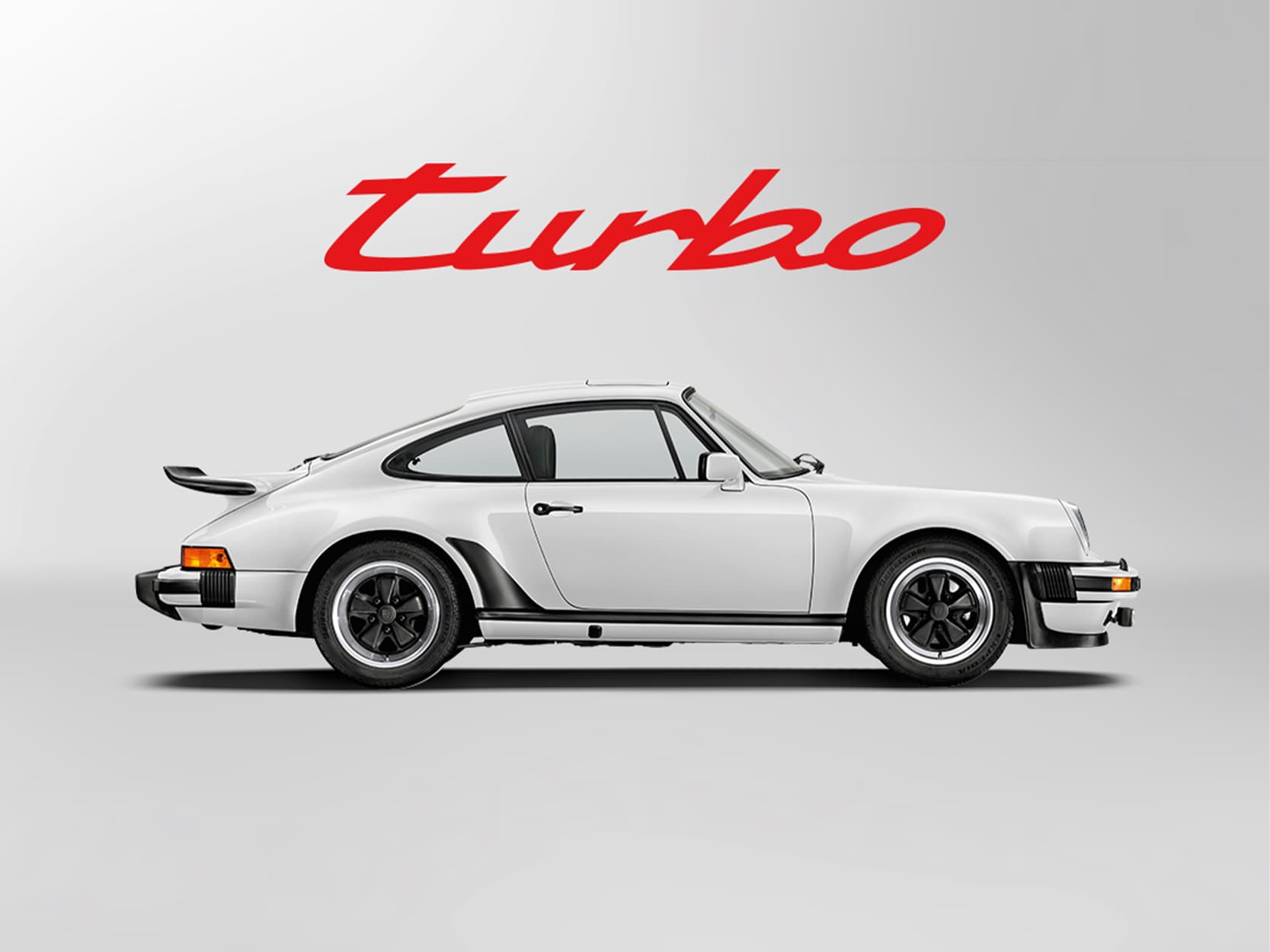 White historic Porsche 911 on a white background with a red Turbo lettering above the car