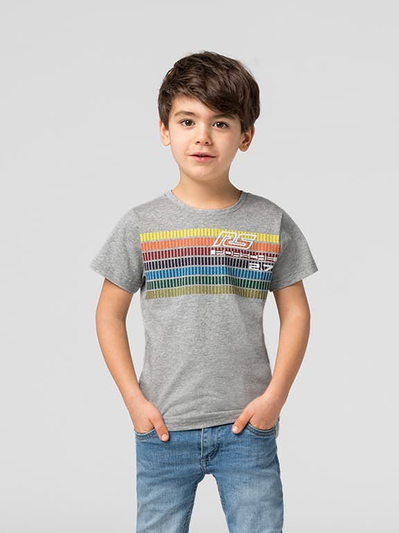 Smiling child in a red and blue plaid shirt with arms raised, sitting in front of an adult on a light background.