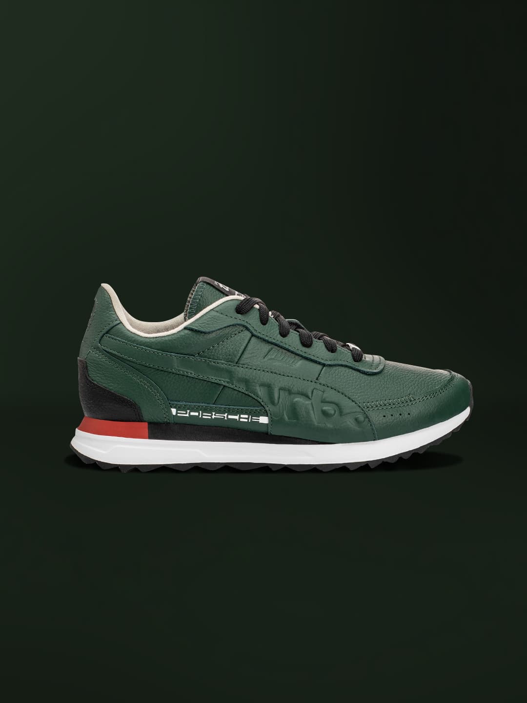 Dark green colored sneaker on a dark green background