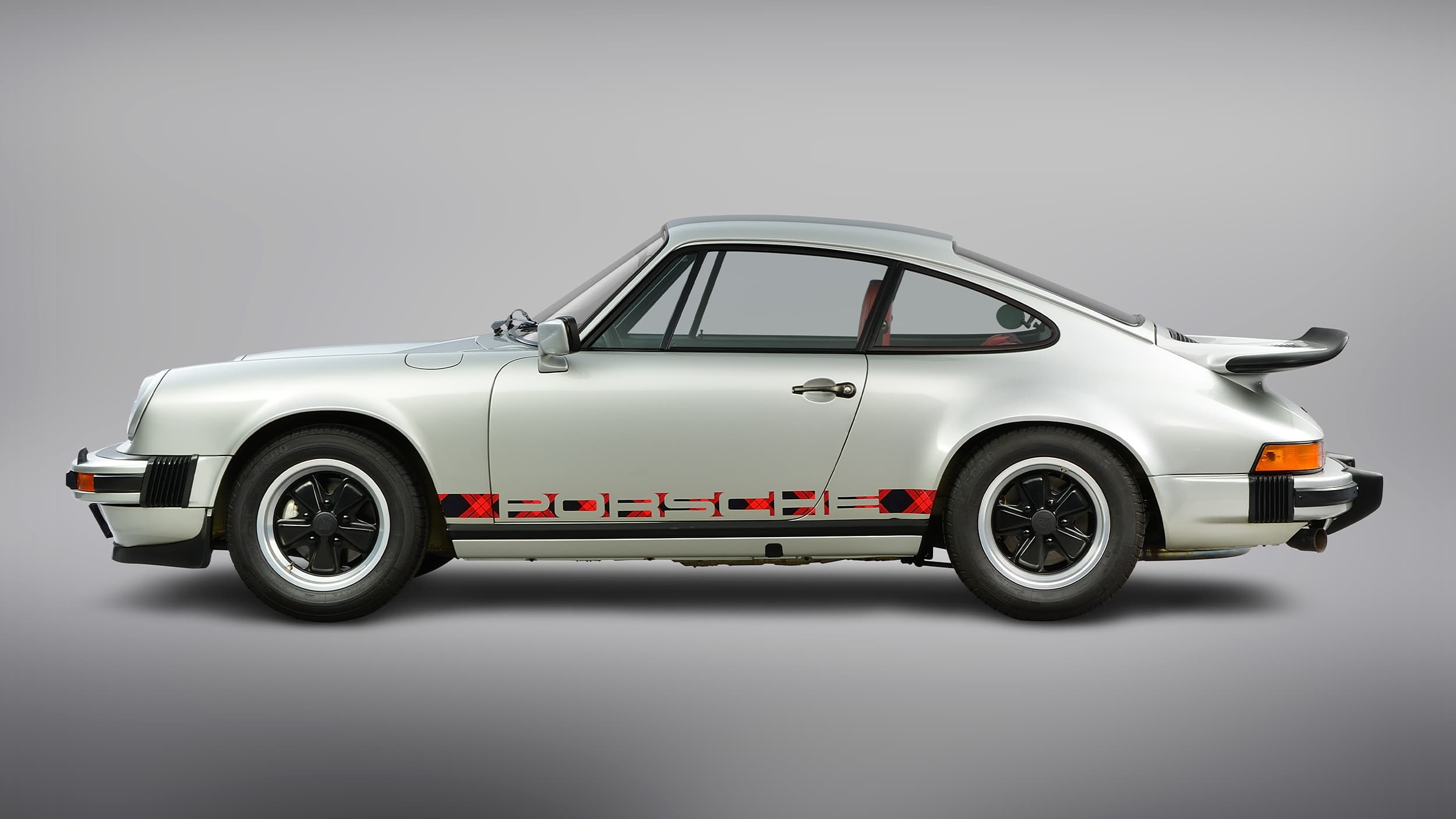 Historic Porsche 911 Turbo in silver on a grey background