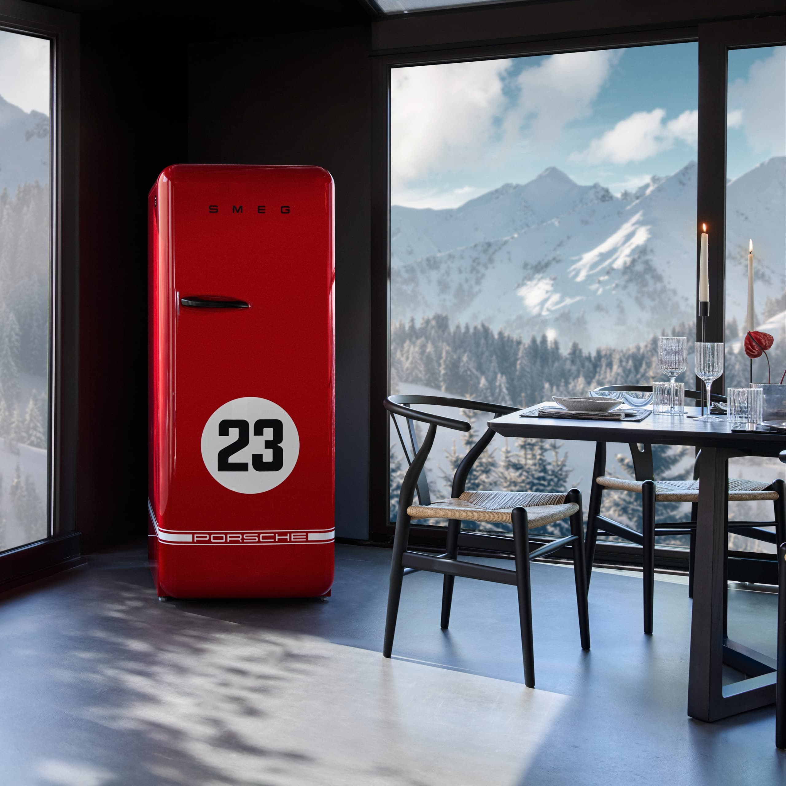 Red SMEG fridge with Porsche logo and number 23, in a modern dining room with mountain view through large windows.