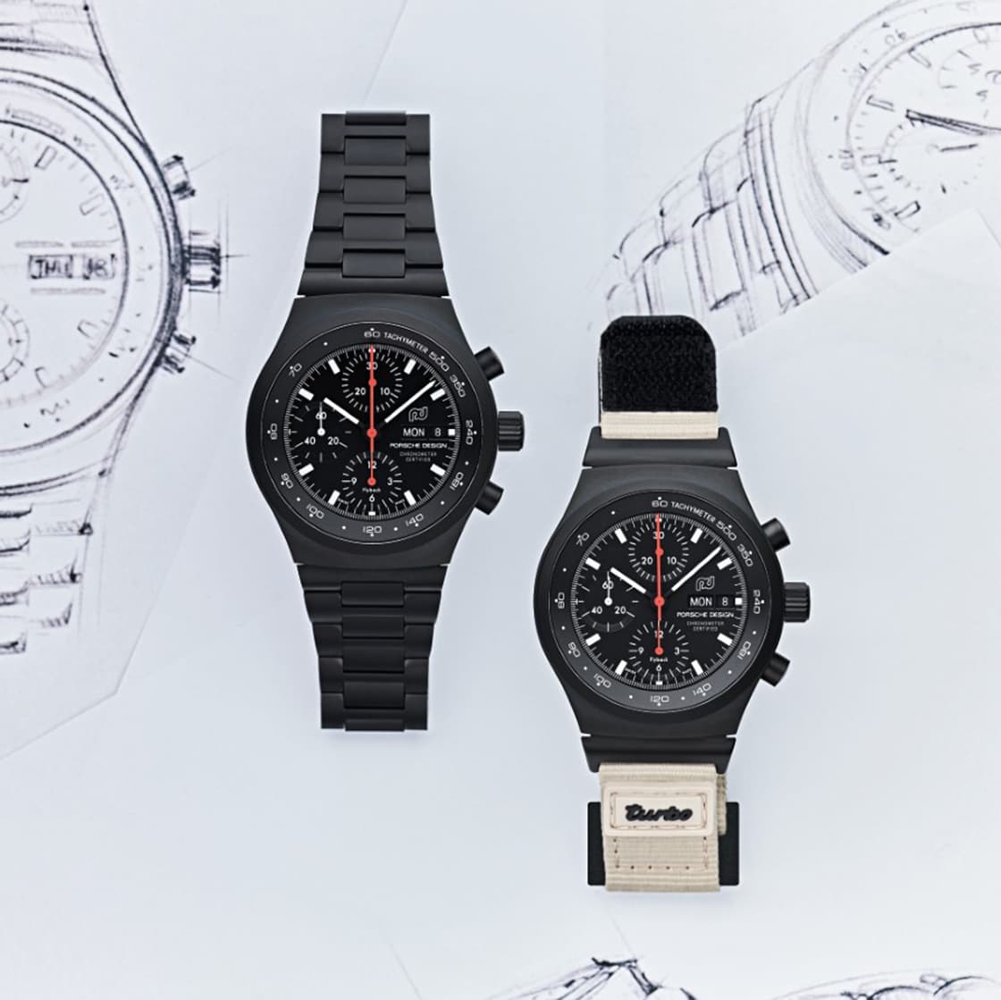 Two Chronograph 1 - 50 Years 911 Turbo Edition lying next to each other, one version with textile strap, the other with black titanium strap