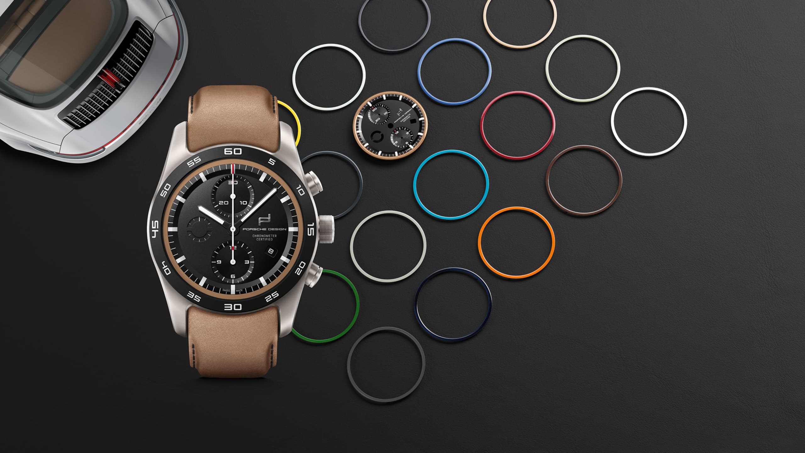 Image shows a Porsche Design Timepieces chronograph with a selection of different bezels.