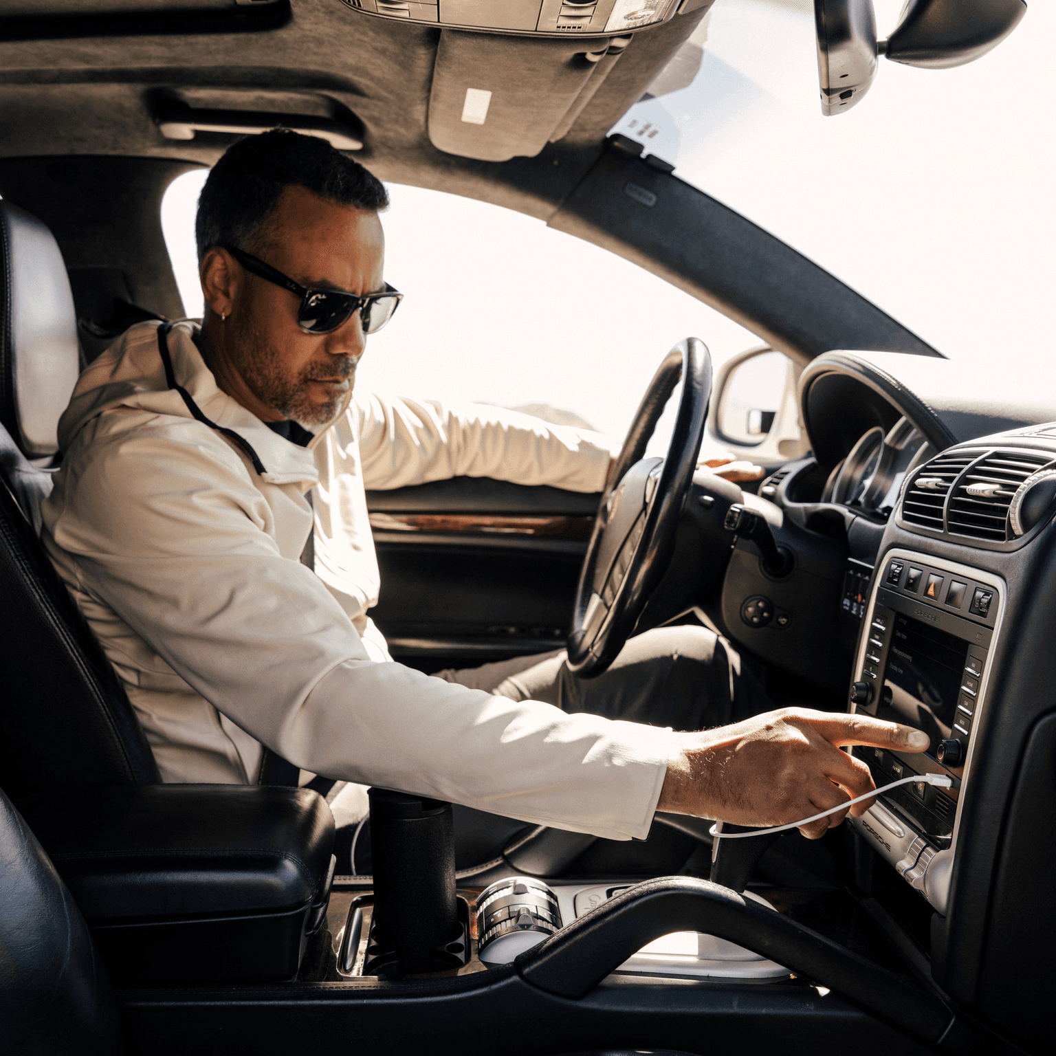 A man sitting in a car and touching the display