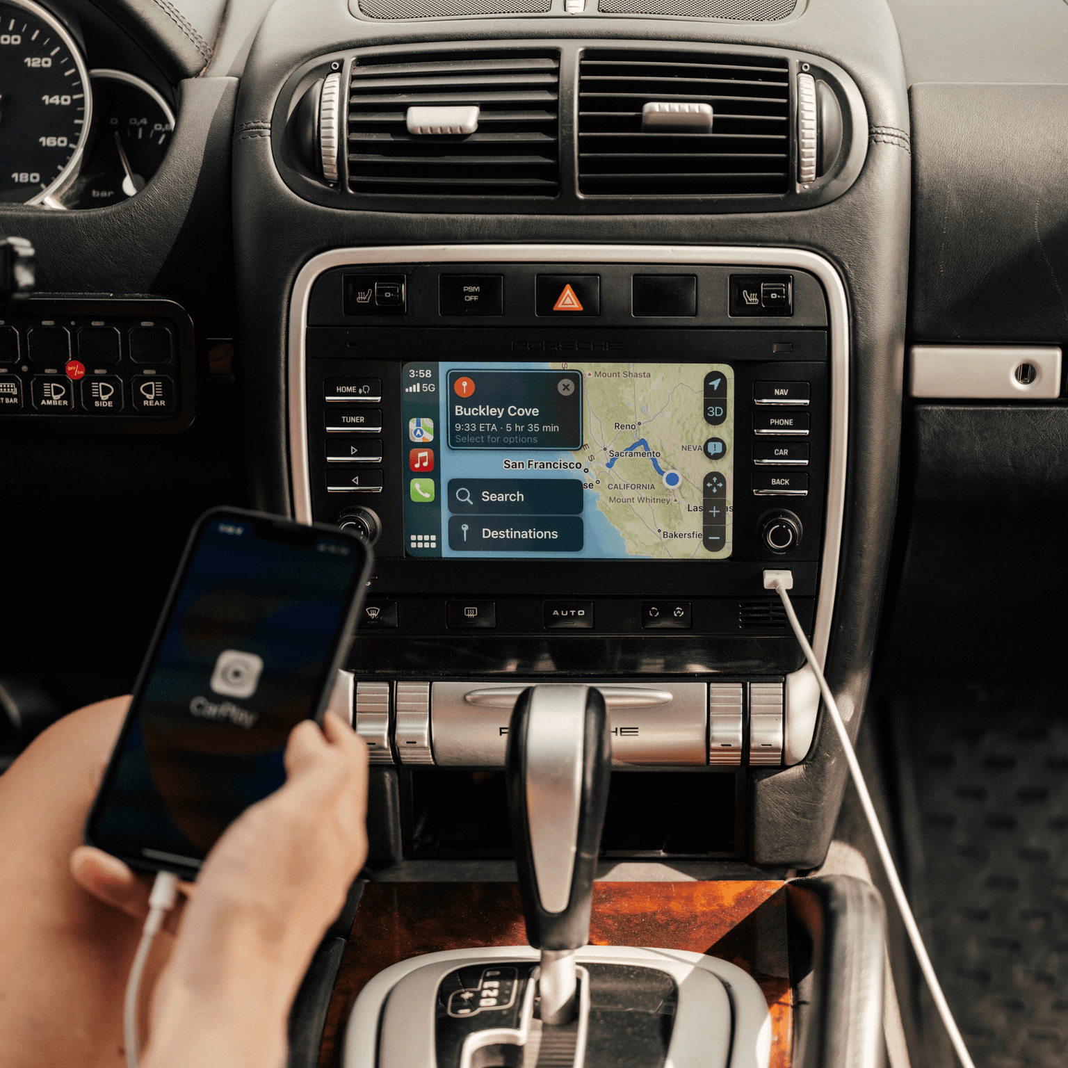 person is holding his smartphone in front of a PCCM systen in the car