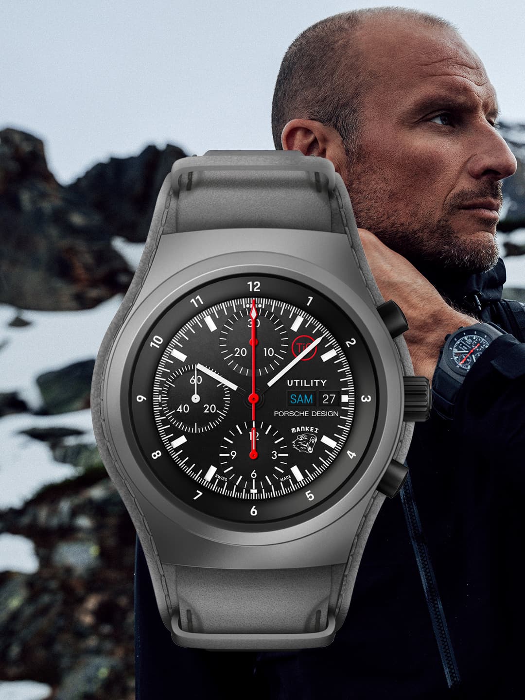 Pictured is the silver Chronograph 1 utility - limited edition from Porsche with a man in the background