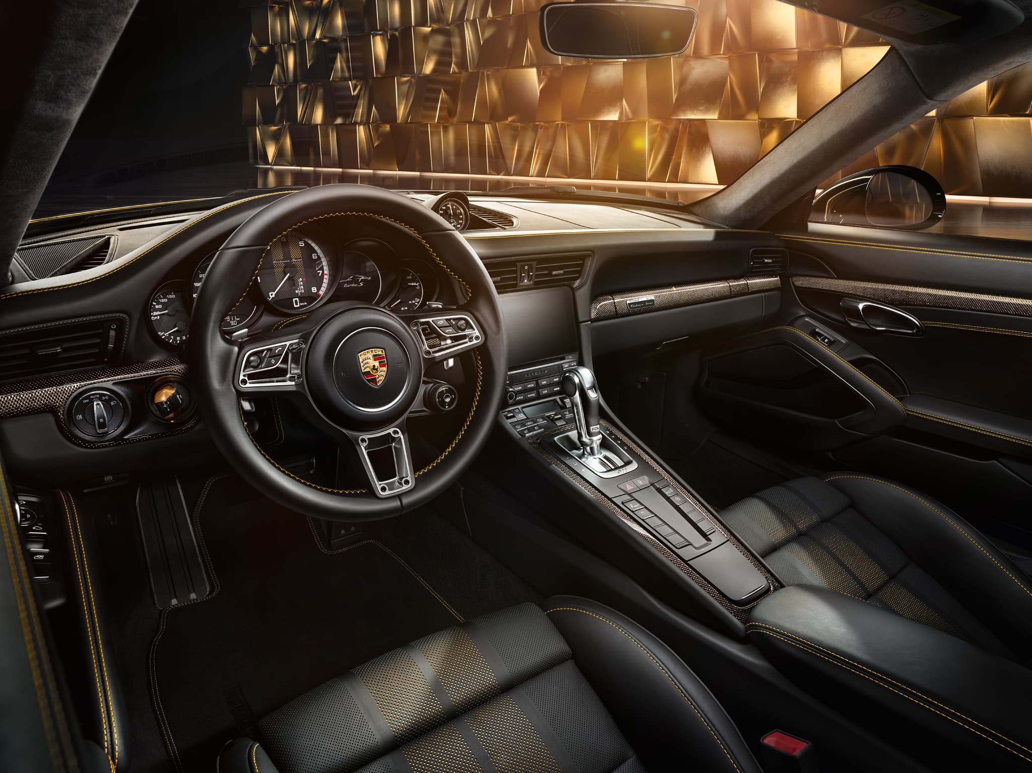 Porsche cockpit interior with black leather seats, yellow stitching, steering wheel and center console, gold backdrop outside