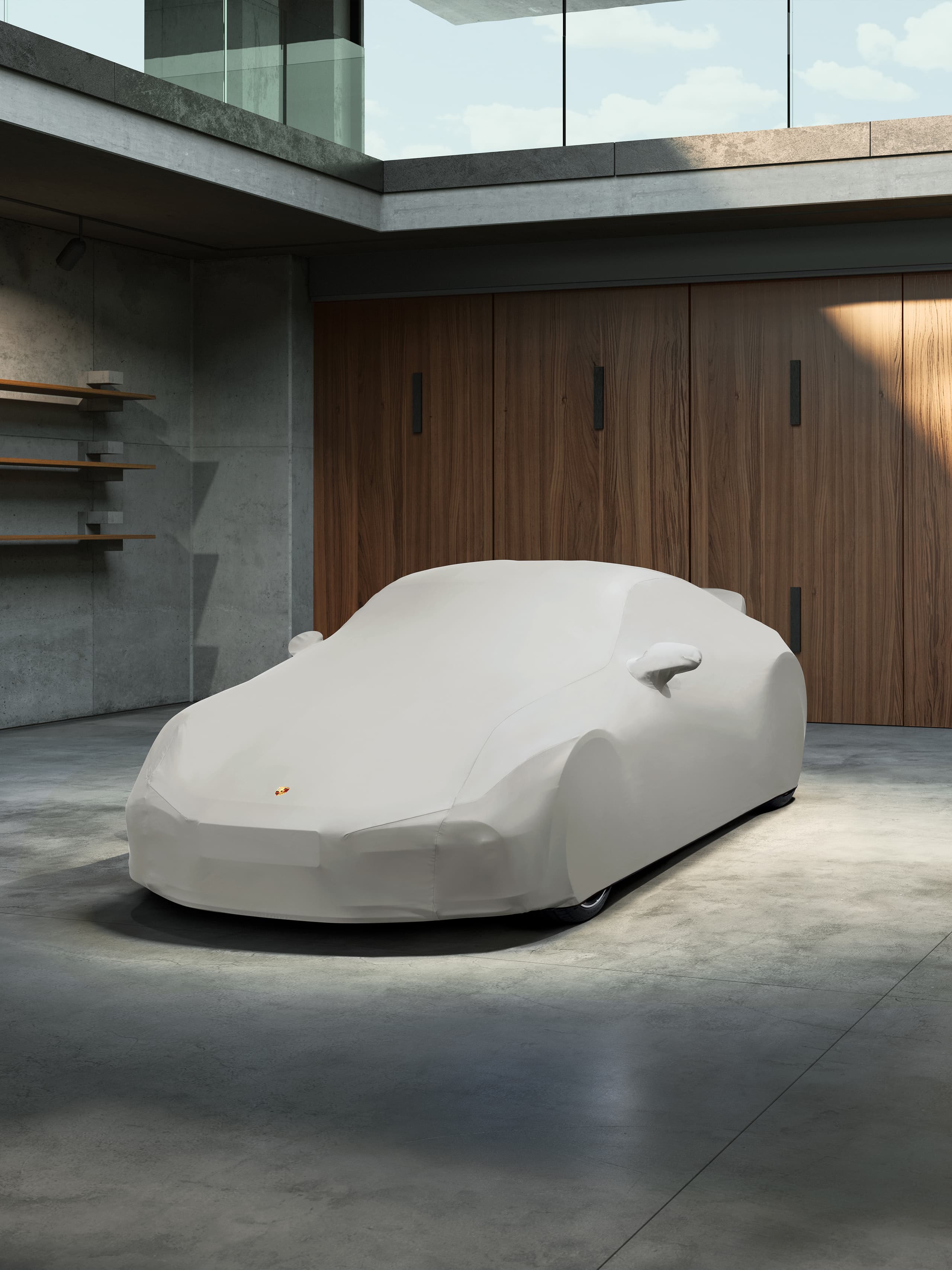 You can see a car beneath a Porsche car cover in the inside