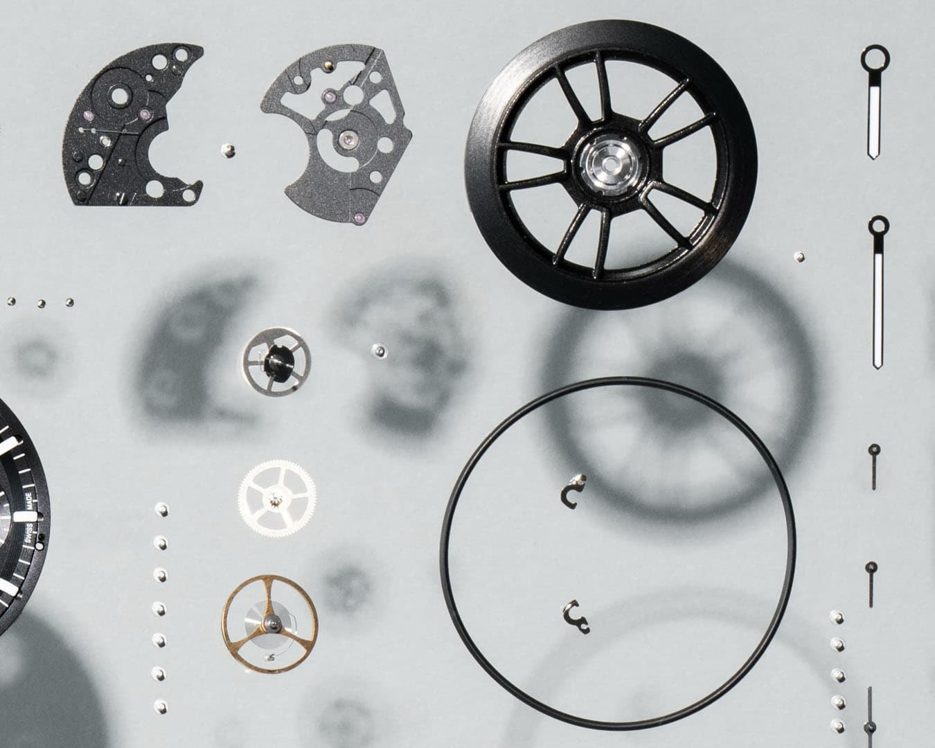 Disassembled parts of a Prosche Design custom-built watch on a light background