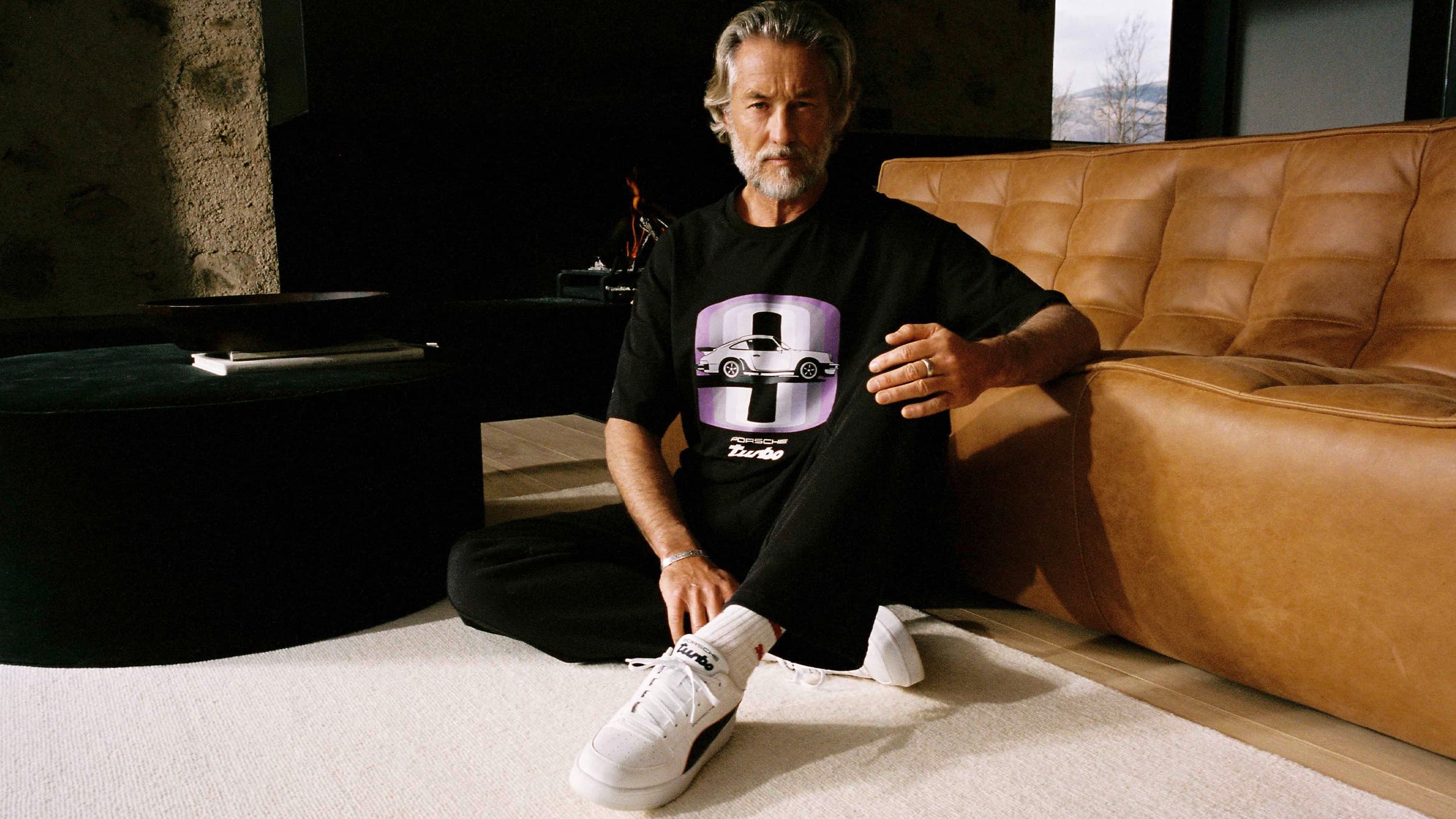 Person wearing a black shirt and white shoes from the new Porsche collection