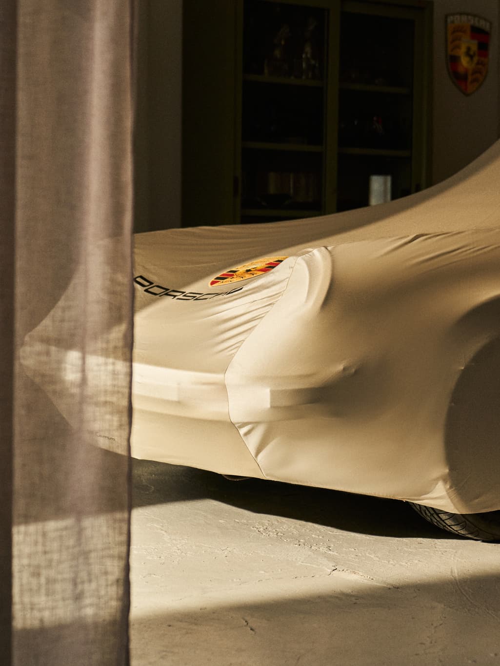 Porsche classic car beneath a Porsche car cover