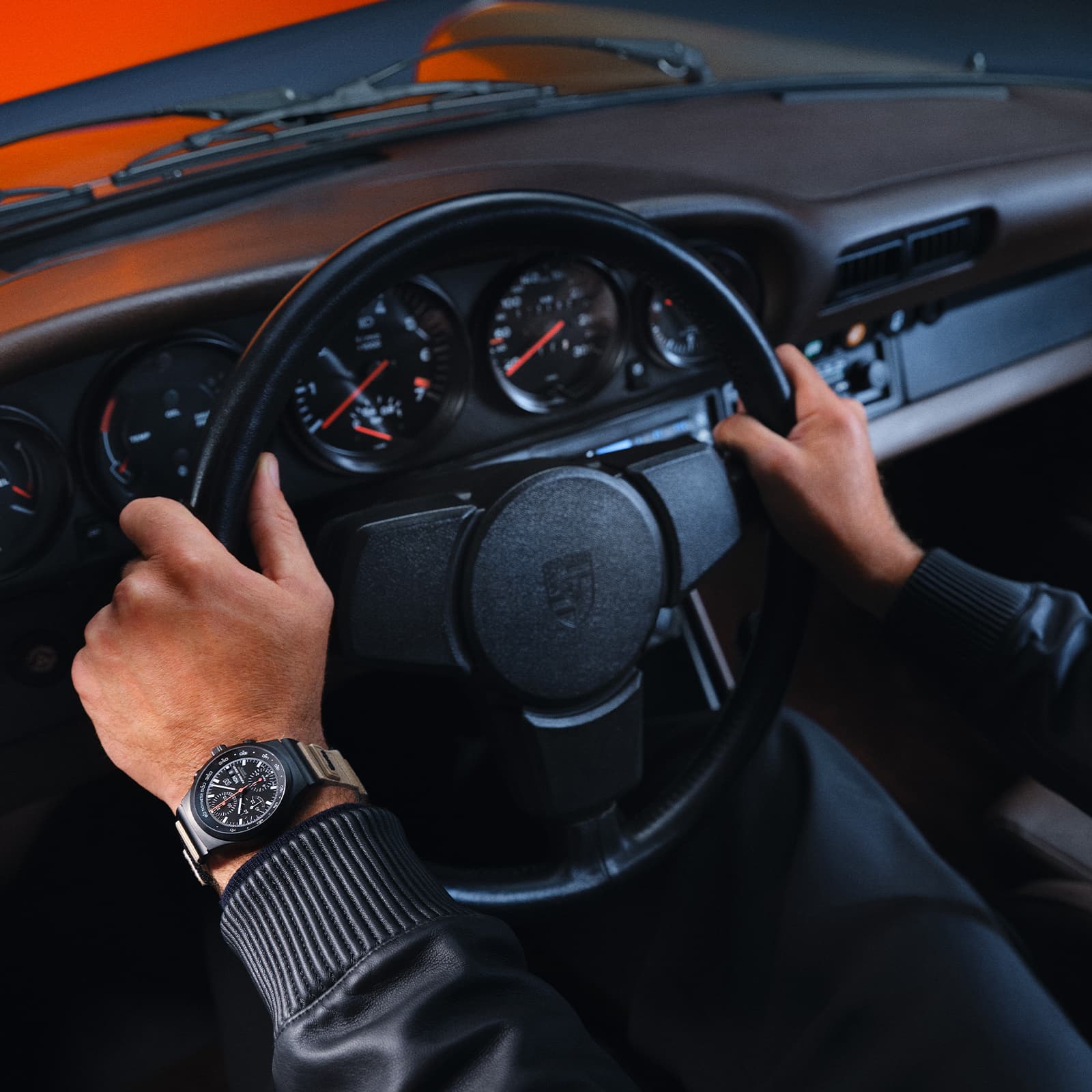 Person is sitting at a steering wheel