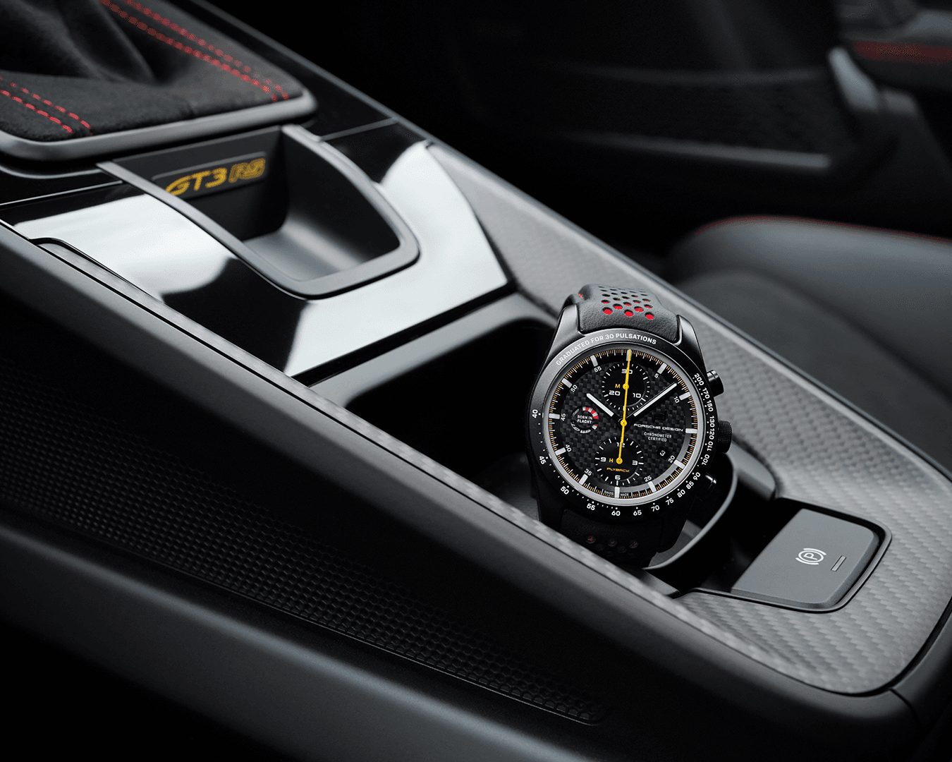 Die Armbanduhr Chronograph 1 GT3 RS von Porsche in einem Getränkehalter in einem Porsche-Fahrzeug.