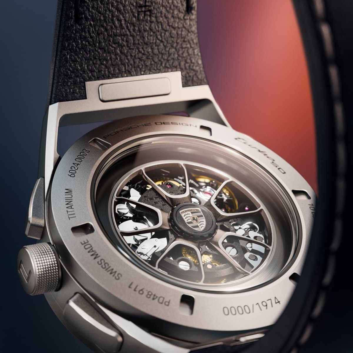 Close-up of the back of a Porsche Design watch made of titanium, featuring a see-through case back and a black strap.