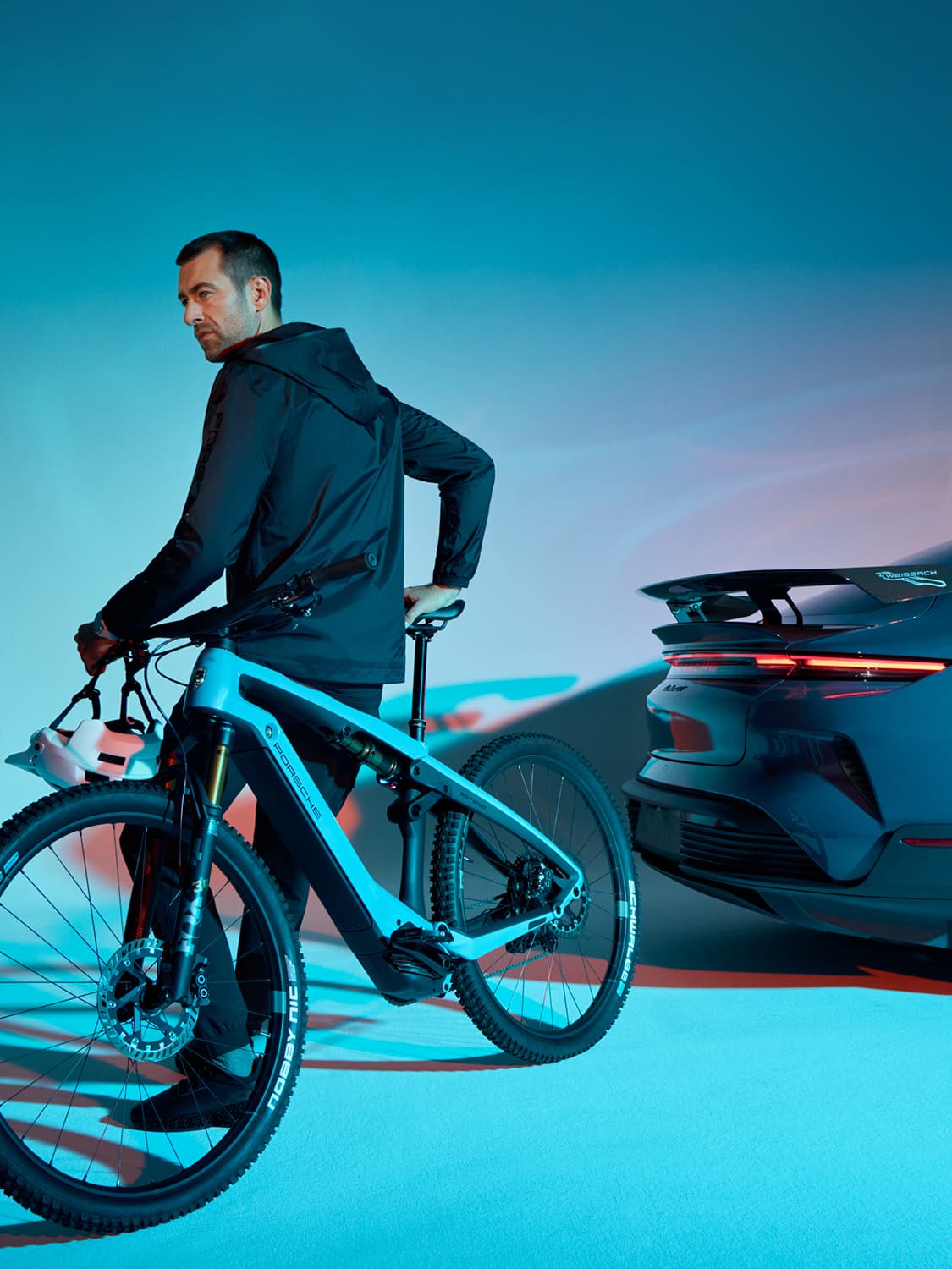Man standing next to a Porsche car with his new eBike