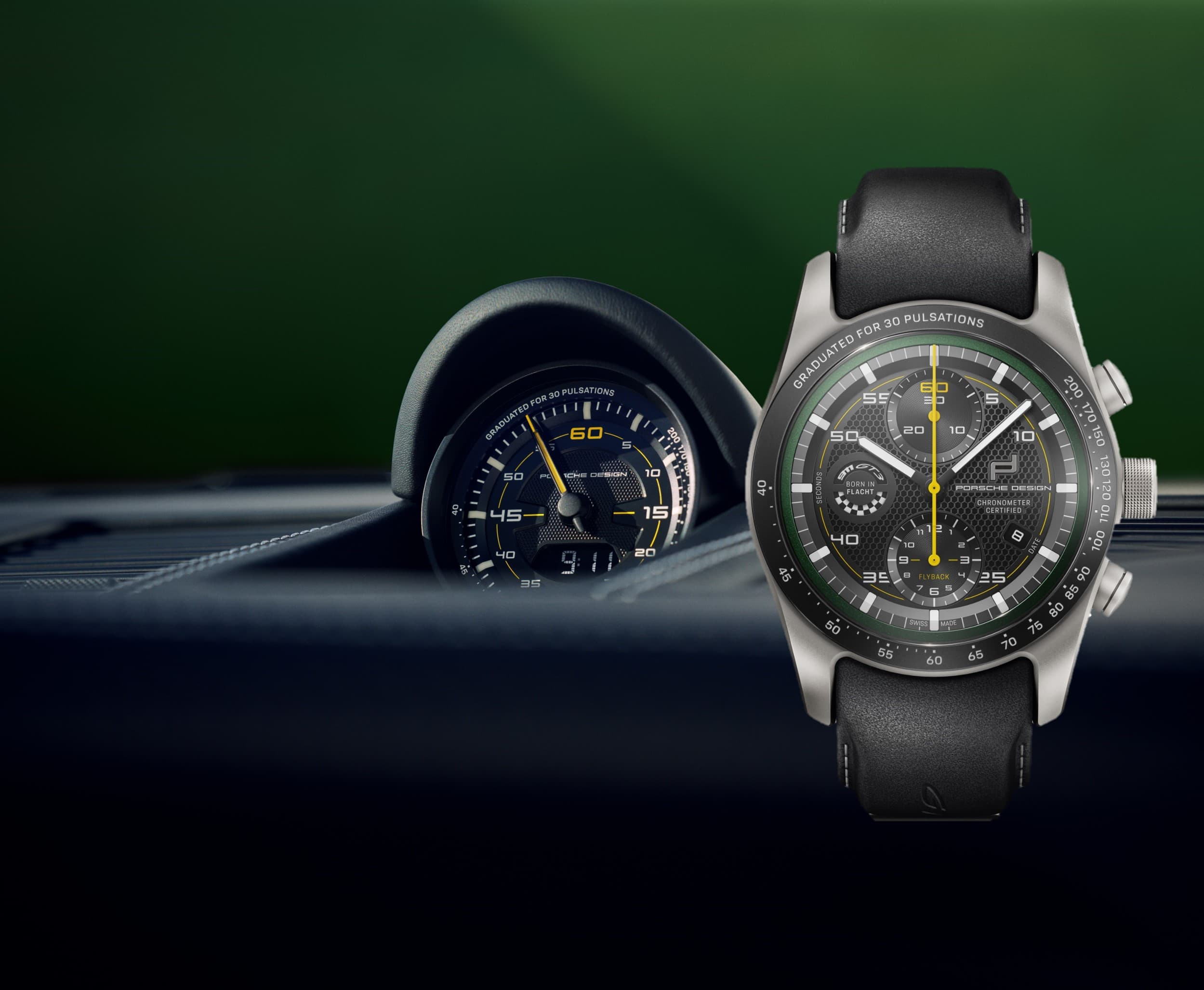 Porsche Design Chronograph watch with black leather strap and yellow accents, shown beside a car gauge on green background.