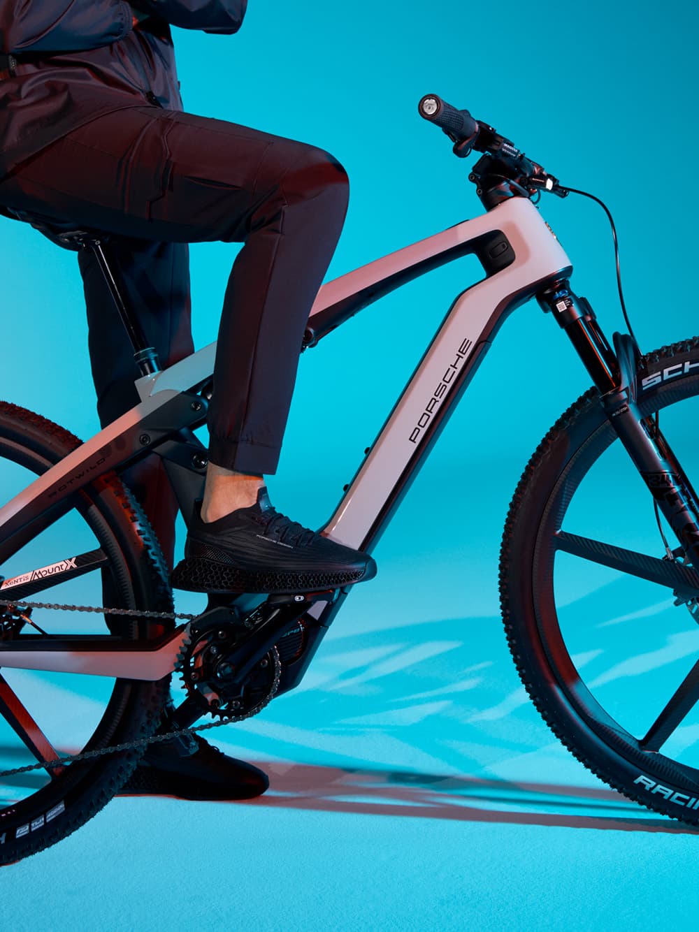 You can see a person on a Porsche eBike, blue background