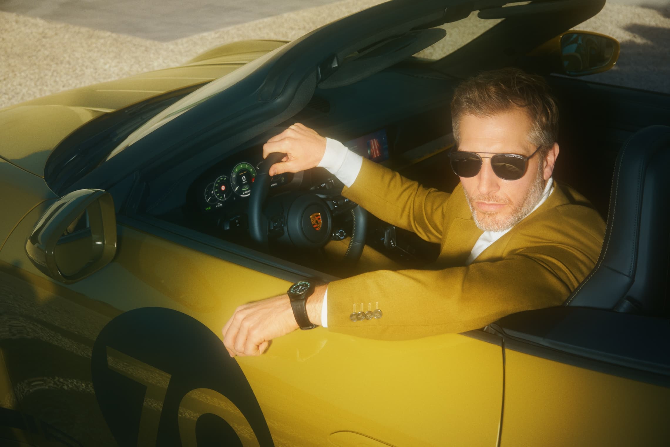 Man sitting in Porsche wearing the Chronograph 911 Spirit 70 on his wrist