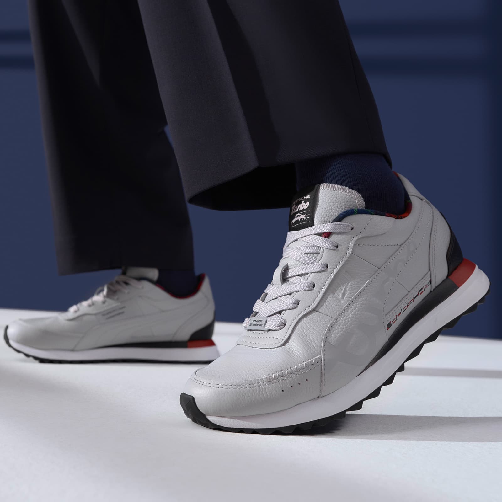 Person is wearing new Porsche 50Y sneaker in lightgrey