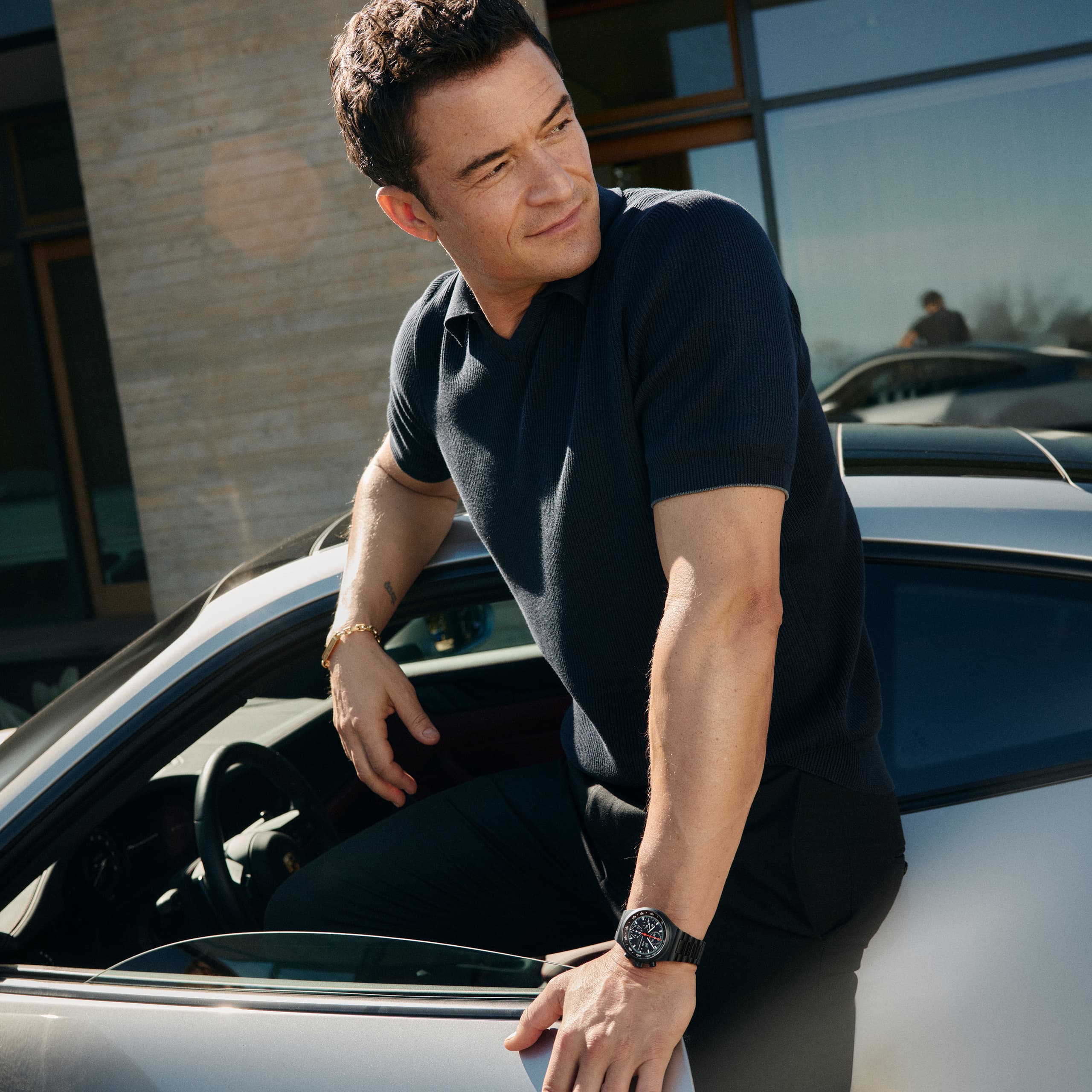 Orlando Bloom wearing the Chronograph 1 - All Black Numbered Edition on his wrist and gets into his Porsche