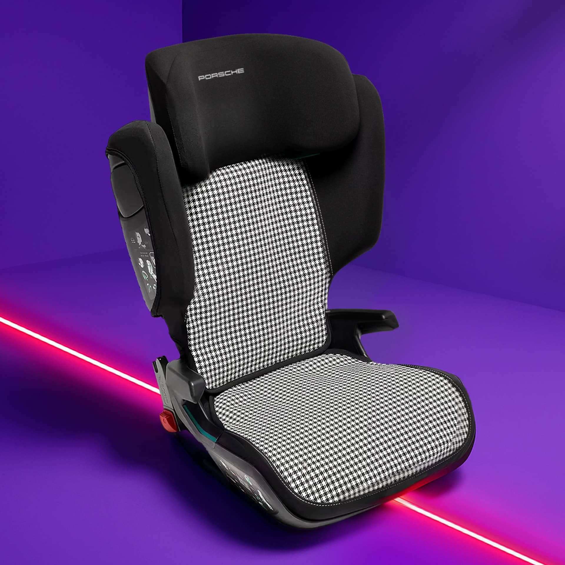 Black and white houndstooth Porsche child seat on a vibrant purple background with a red diagonal line.