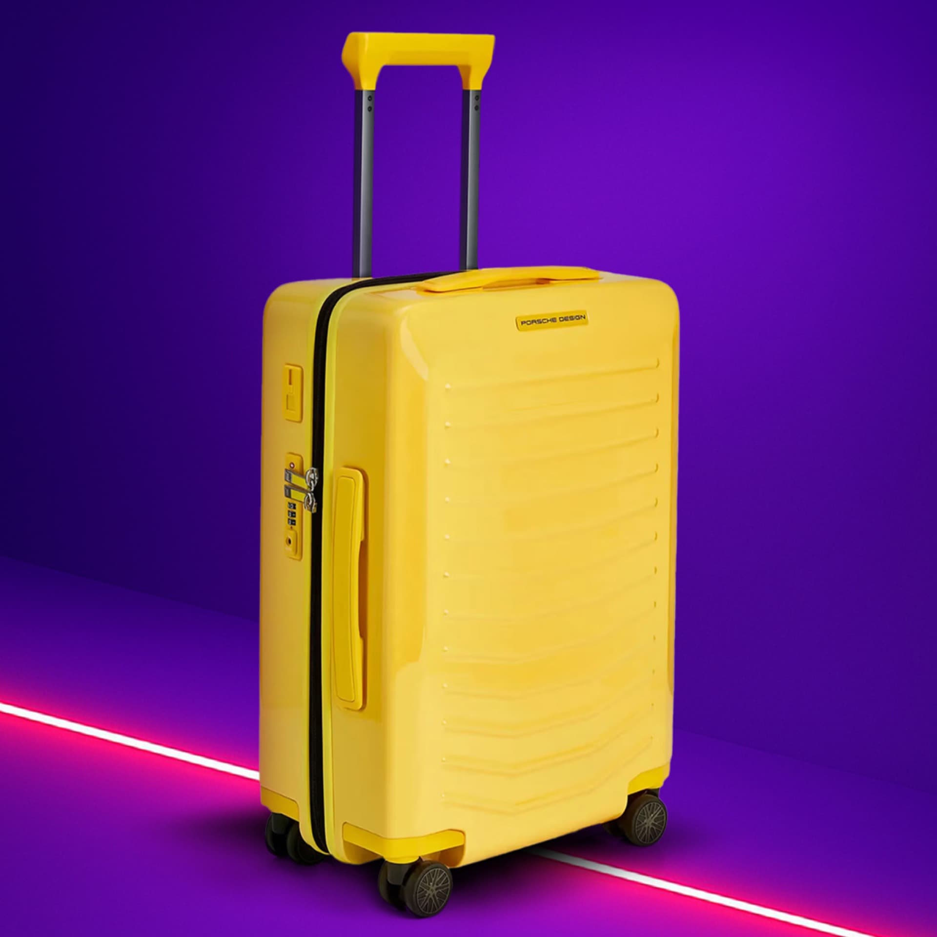 Yellow suitcase with telescopic handle on purple background, featuring Porsche Design logo and four wheels.
