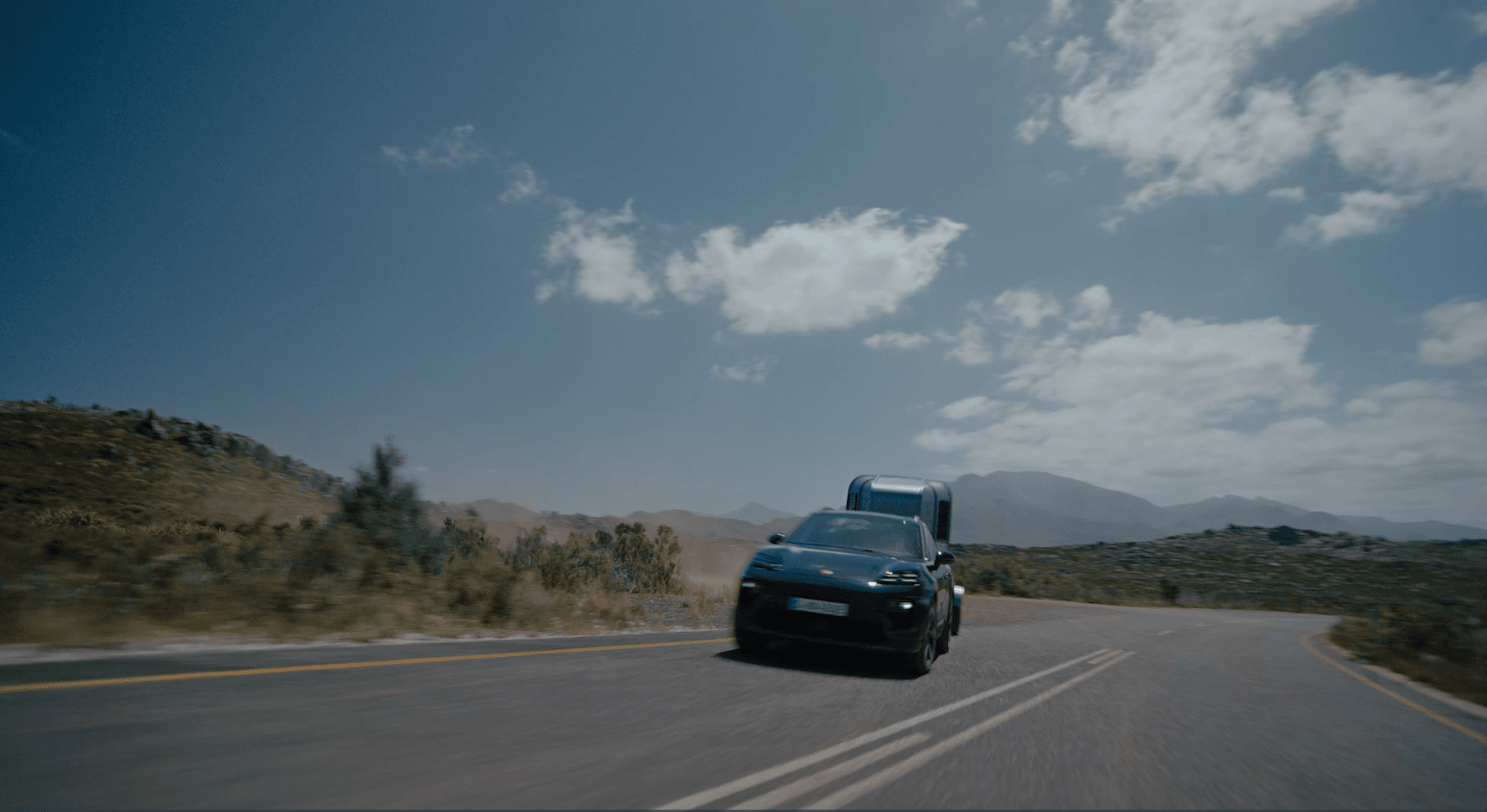 Oakgreen Porsche Macan on a road